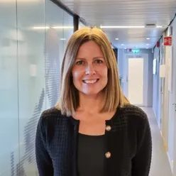 En kvinne som smiler i en gang